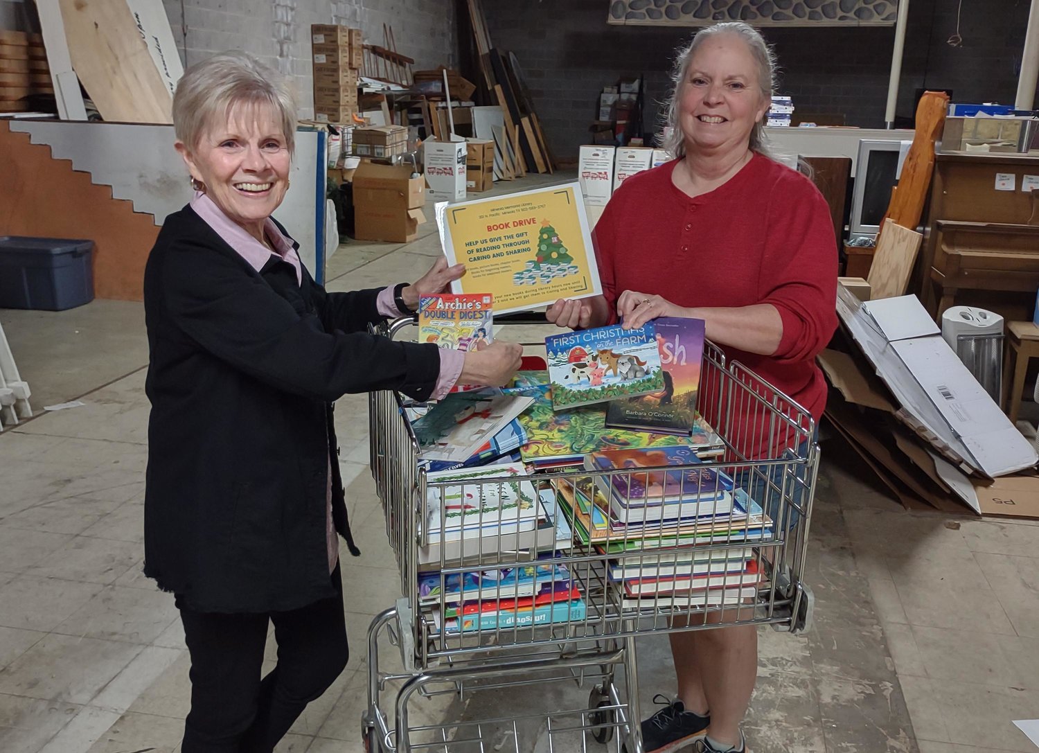 Mineola Memorial Library made a book donation to Mineola Caring and Sharing. Beth Shockey, Caring and Sharing, left, accepts from Mary Hurley, Mineola Memorial Library.